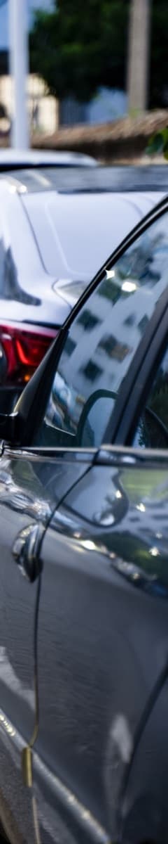 Cars parked nose to tail along a kerb
