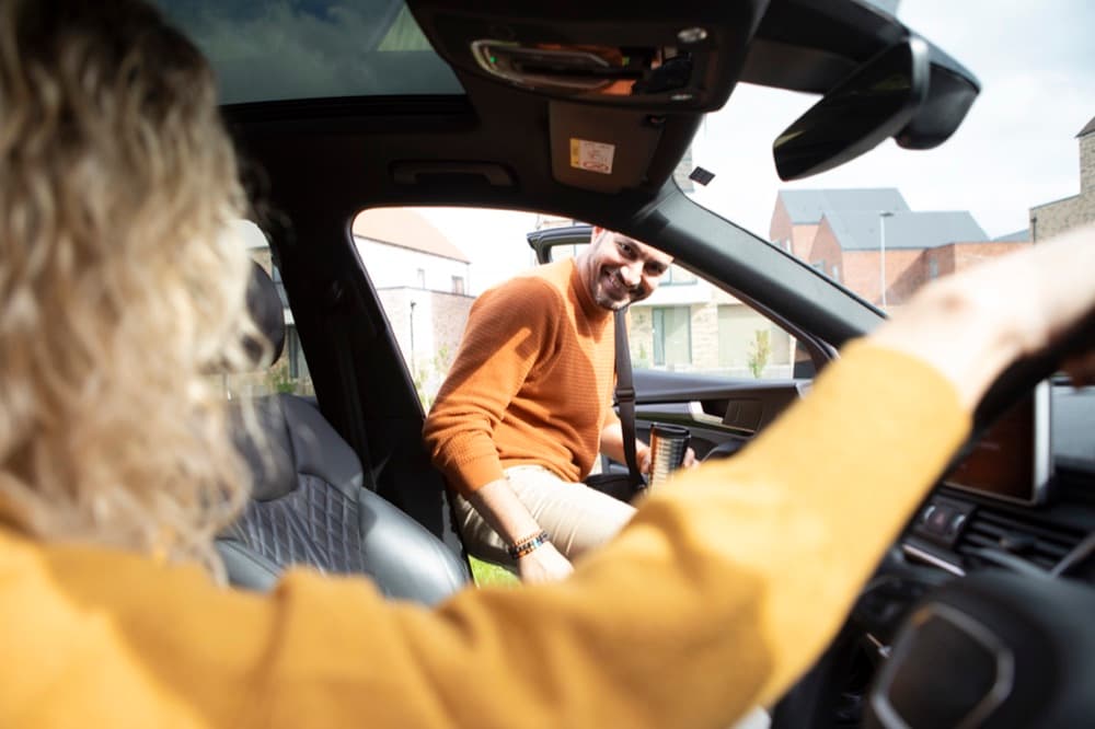 Two people swapping over a shared car