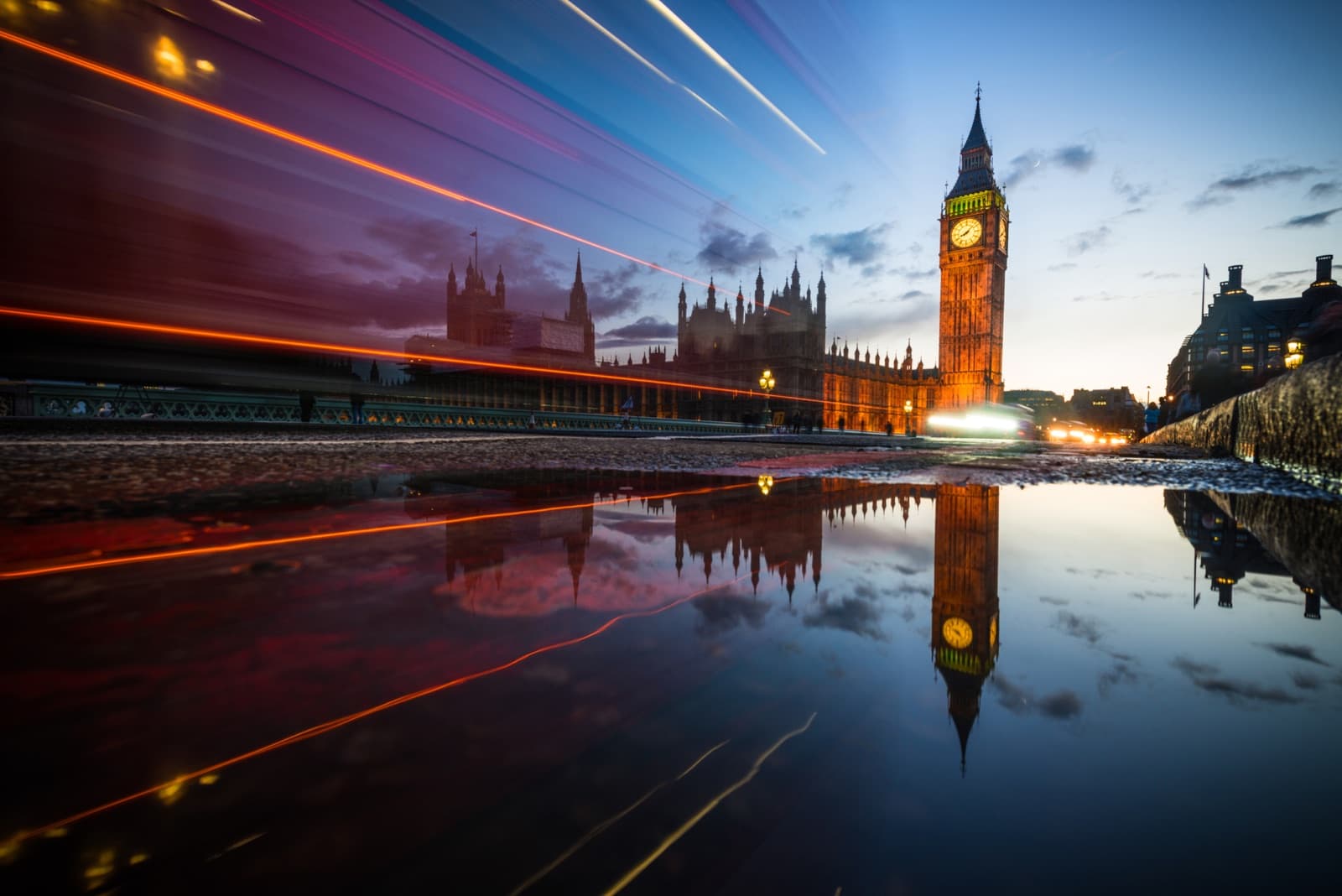 Big Ben and Westminster at dusk with bus light trails